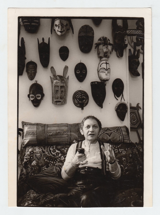 Photograph of Maryan in his apartment and studio at the Chelsea Hotel surrounded by African masks